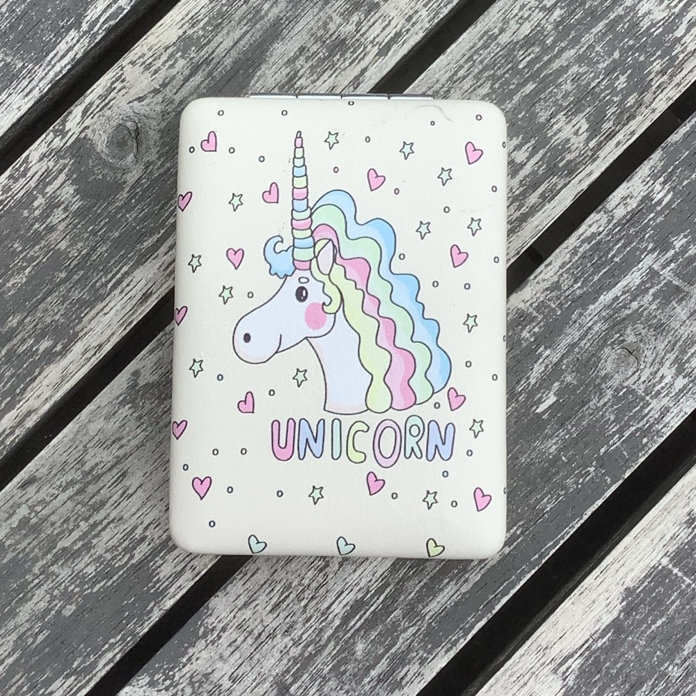 Folded pocket mirror with unicorn pic on it.